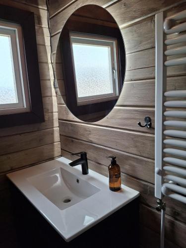 a bathroom with a sink and a mirror at Country cottage in Þingeyjarsveit