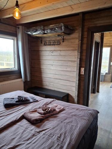 a bedroom with a large bed in a cabin at Country cottage in Þingeyjarsveit