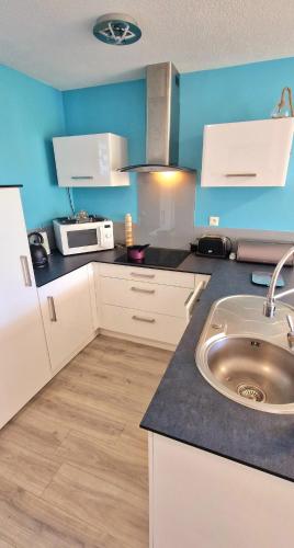 une petite cuisine avec un évier et un micro-ondes dans l'établissement 