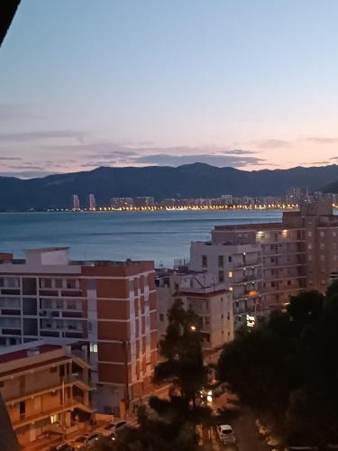 a view of a city with the ocean and buildings at Cullera Playa de los Olivos Apartment in Faro de Cullera