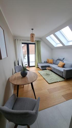 a living room with a couch and a table at Apartment am See mit Dachterrasse in Bergkamen