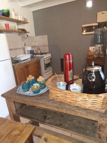 a kitchen with a table with a basket on it at Quinta Los Sauces Suipacha in Suipacha