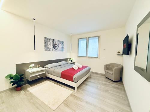 a bedroom with a bed and a chair in it at Bgy Airport Lake Iseo Free Wi-Fi in Telgate