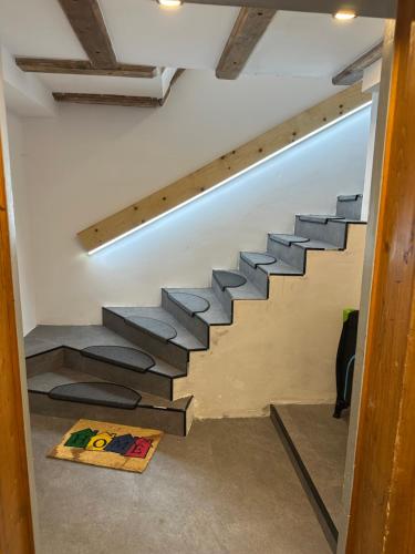 a staircase in a living room with a stair case at Landhaus Alpenblick in Obsteig