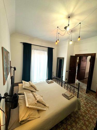 a bedroom with a large bed with towels on it at Appartamento Porto Marina S G in Licata