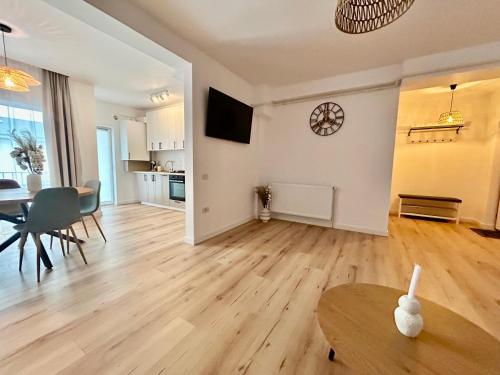 a living room with a table and a dining room at Bucovina Home Apartament in Gura Humorului