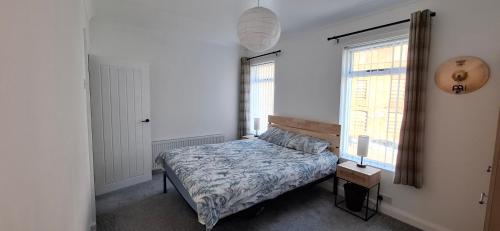 a bedroom with a bed and a window at Home away from home in Belfast