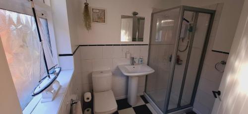 a small bathroom with a sink and a shower at Home away from home in Belfast