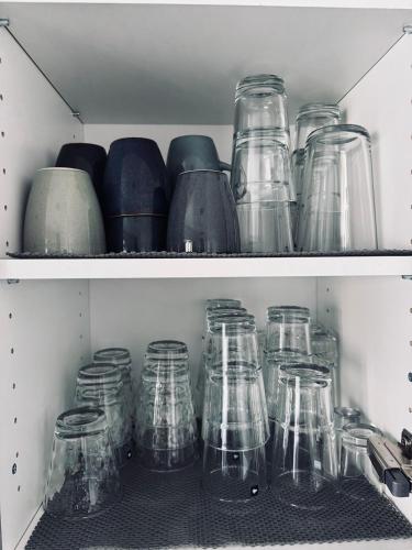 a bunch of glass jars sitting on a shelf at Ferienwohnung am Hoeschplatz in Düren - Eifel
