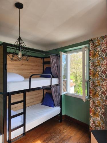 a room with bunk beds and a window at Gite Compostella in Saint-Jean-Pied-de-Port