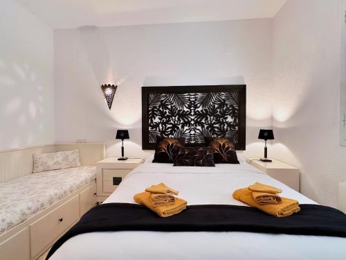 a bedroom with a large bed with towels on it at Beautiful Villa Close to Xabia & Moraira in Benitachell