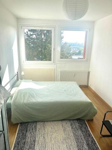 une chambre avec un lit et deux fenêtres dans l'établissement Ma parenthèse, à Dieppe