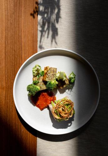 a plate of food with broccoli and noodles on a table at Jordan's Untermühle in Köngernheim