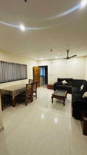 a living room with a couch and a table at Hotel Gokulam Grand in Pithāpuram