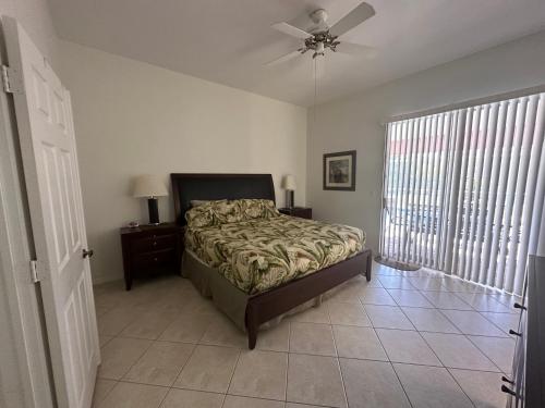 a bedroom with a bed and a ceiling fan at Villa Vera with Lake view in Naples