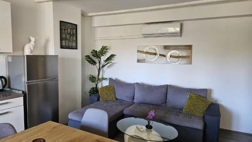 a living room with a blue couch and a table at Vila Emona in Mali Lošinj