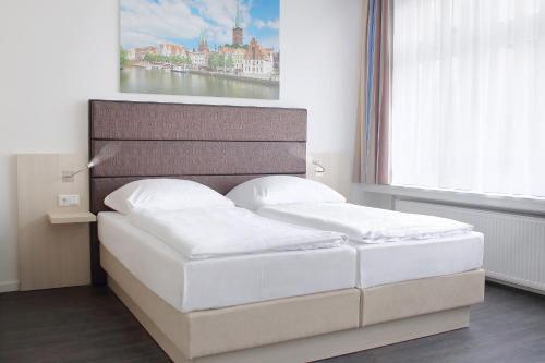 Postel nebo postele na pokoji v ubytování Viva Hotel Lübeck