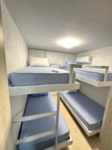 a room with several bunk beds in it at Luxury norte Barranquilla in Barranquilla