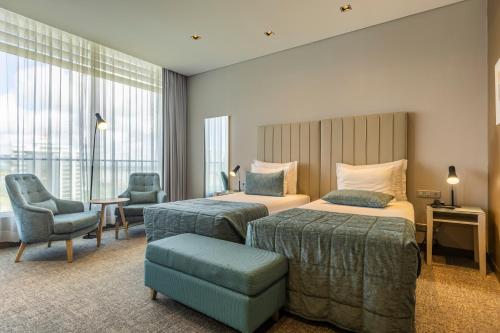 Postel nebo postele na pokoji v ubytování Montebelo Girassol Maputo Hotel