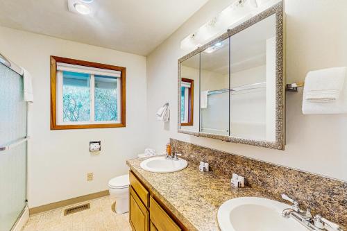 a bathroom with a sink and a toilet and a mirror at Falcon's Nest in Twin Rocks