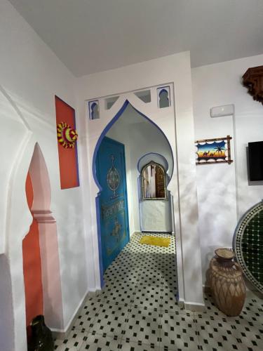 a room with a blue door and a tile floor at Casa Blue Star in Chefchaouene