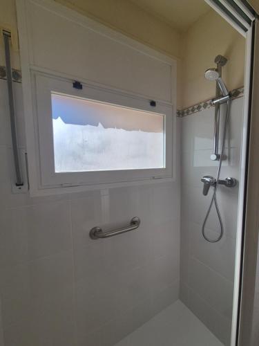 a bathroom with a shower with a window at Apartament Roqueta in Palamós