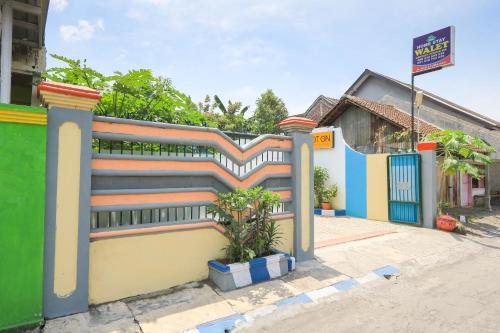 a colorful fence in front of a house at Hotel O Wallet Family Residence Syariah in Lumajang