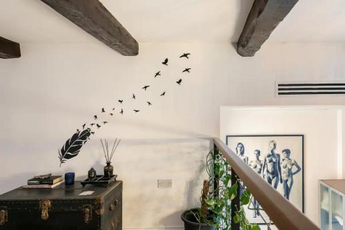 a group of birds on a wall in a room at Rooftop Heated Jacuzzi, Fireplace, A Unique Home! in Żebbuġ
