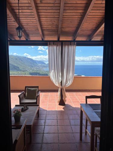 a screened in porch with a view of the ocean at Vv Las Vistas in Icod de los Vinos
