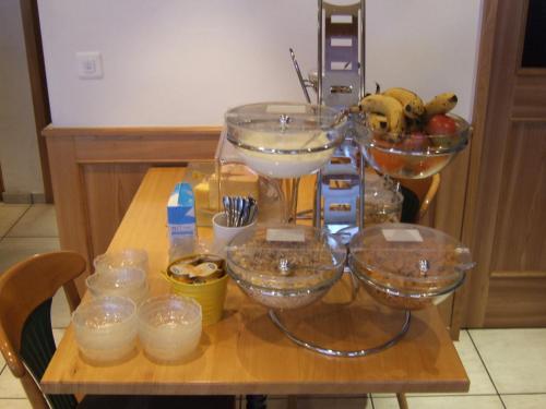 a table with bowls of food and other items on it at Gasthaus Pension zum Turm in Hospental