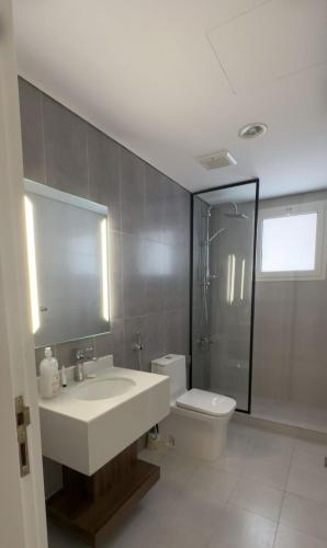 a bathroom with a sink and a toilet and a shower at Dar Al Mashaer Luxury Apartment #112 in Mecca