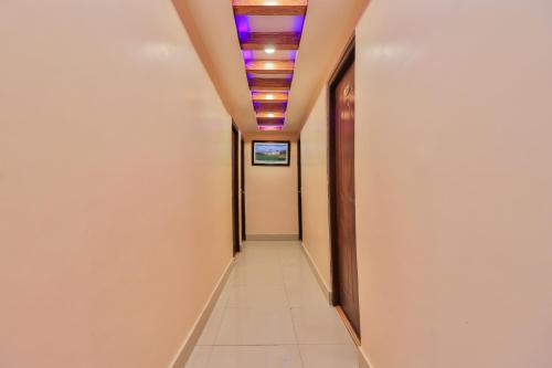 a corridor in an office building with a ceiling with lights at OYO 676 Hotel Maalaxmi Inn in Pashupatināth