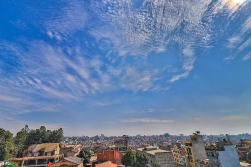 a city under a blue sky with clouds at OYO 676 Hotel Maalaxmi Inn in Pashupatināth