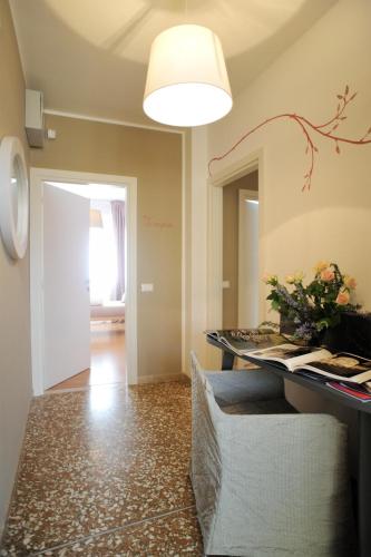 a room with a table with a vase of flowers at Stop & Sleep Udine in Udine