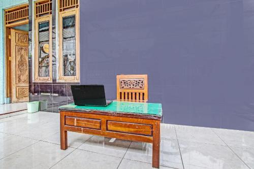 a desk with a laptop sitting on top of it at OYO Life 2546 Griya Widya Syariah in Klaten