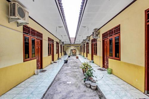 an empty hallway of a building with potted plants at OYO Life 2546 Griya Widya Syariah in Klaten