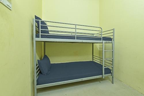 a bunk bed in a room with a blue pillow at Hotel O Sohotel in Klang