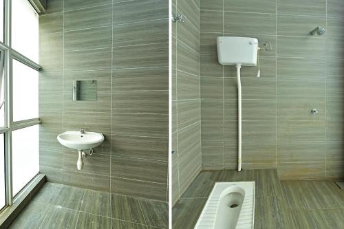 a bathroom with a toilet and a sink at Hotel O Sohotel in Klang