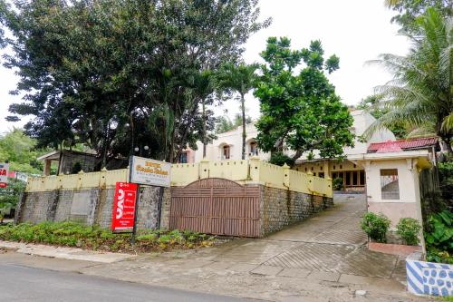 a yellow fence in front of a house at Hotel O otel Graha Prima in Tamperan