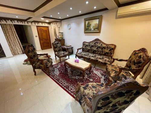 a living room with couches and a coffee table at شقة عائليه كبيره مطله علي قناة السويس والبحر 702 in Port Said