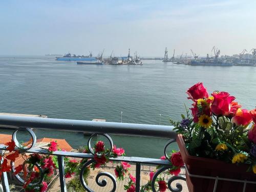 a balcony with flowers and a view of the water at شقة عائليه كبيره مطله علي قناة السويس والبحر 702 in Port Said