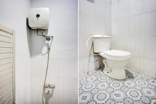 a bathroom with a toilet and a shower at Hotel O Pancing Near Universitas Negeri Medan UNIMED Formerly Nadira Homestay in Medan