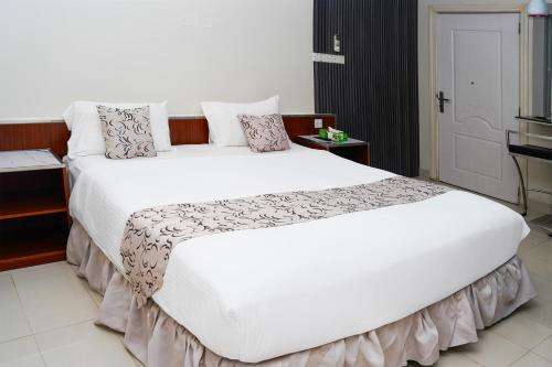 Postel nebo postele na pokoji v ubytování Palette Muscat Al Bayrahaa