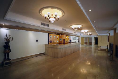 a large room with a lobby with a bar in it at OYO 112 Semiramis Hotel in Manama