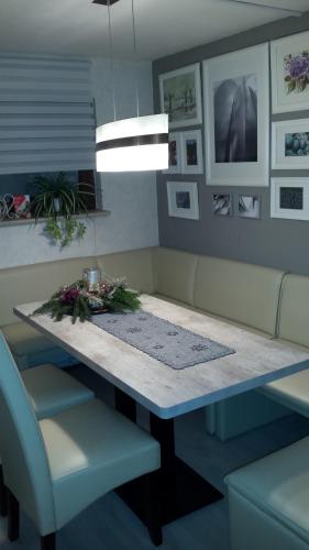 a dining room table with two chairs and a couch at Logis Am Park in Dessau