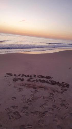 a message written in the sand on a beach at Global Sun - Casa Pasco in Playa de Gandia