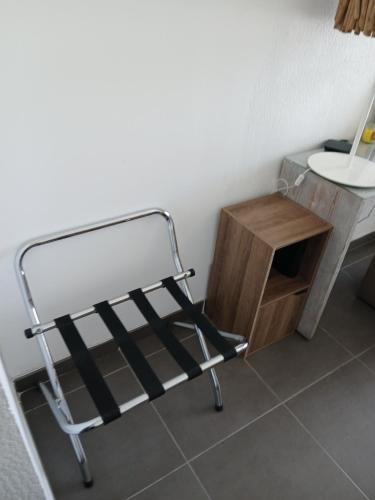 a bathroom with a metal rack next to a table at bonheurpointcom in Saint-François