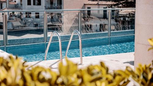 a swimming pool with a fountain in a building at Gran Hotel Soller in Sóller