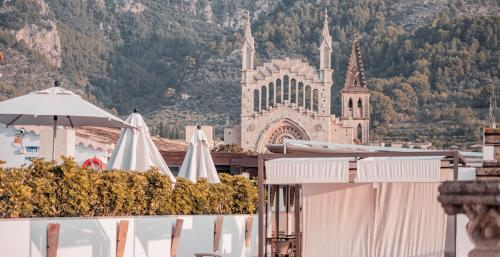 a view of a building with umbrellas and a cathedral at Gran Hotel Soller in Sóller