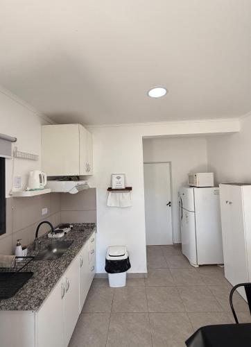 a kitchen with a sink and a refrigerator at Rincón del Chajá n°3 in Chajarí